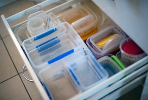 Plastic food containers filling a kitchen draw