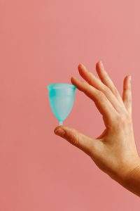 silicone menstrual cup being held by a hand 