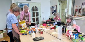 People of community kitchen cooking the recipes
