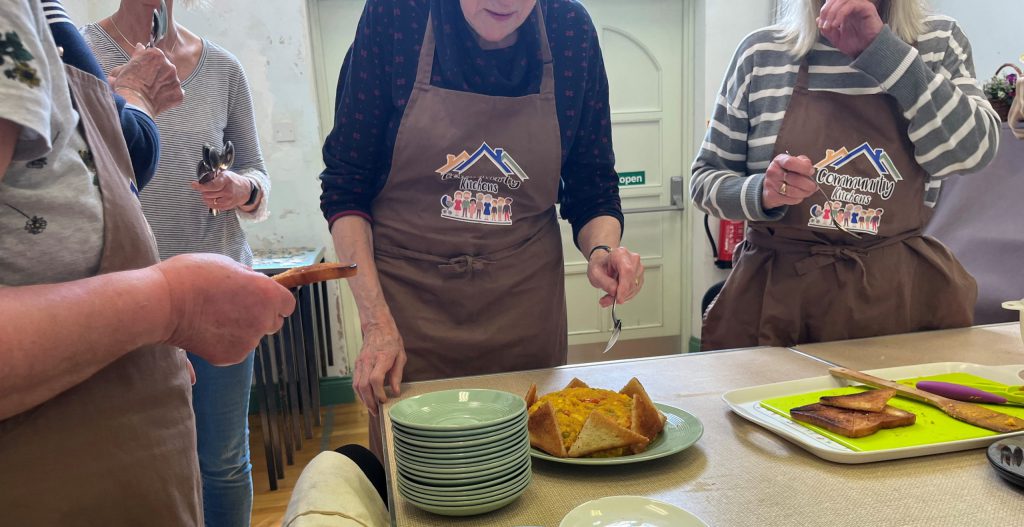 Community Kitchen tasting the spicy rice recipe