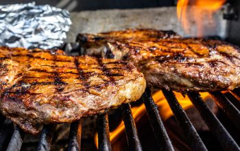 Food cooking on a BBQ grill