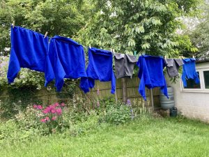 photo of items of school uniform displayed on a washing line in someone's garden