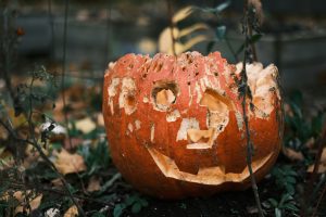 A carved pumpkin that is decomposing